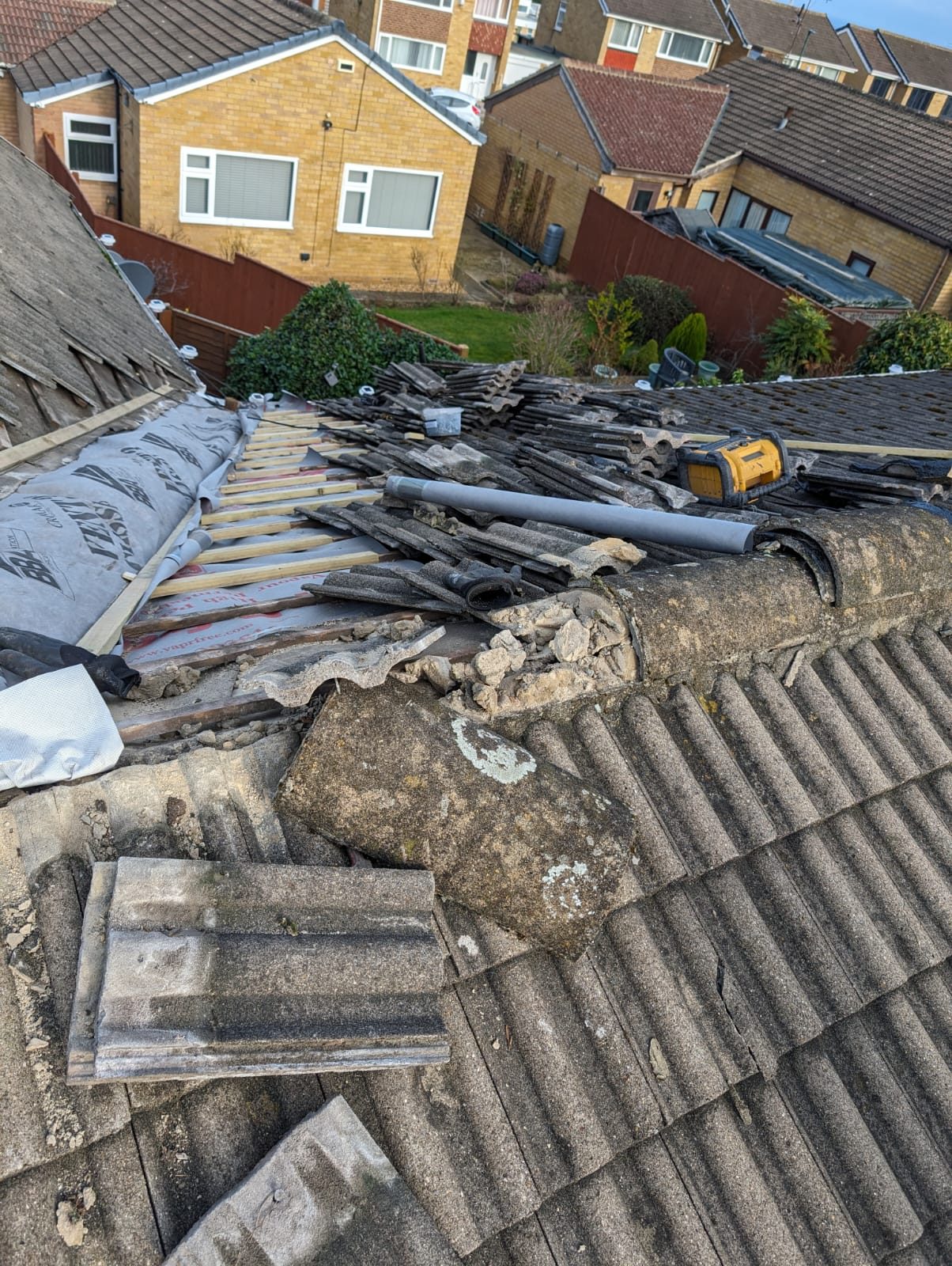 An old roof stripped back to the battens with new underlay going down